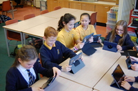 image of children round table on ipads